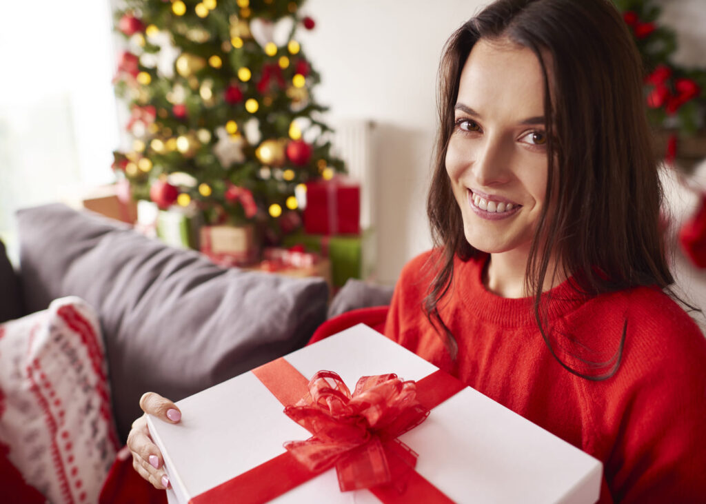 femme-qui-tient-un-cadeau-de-noel-dans-les-mains