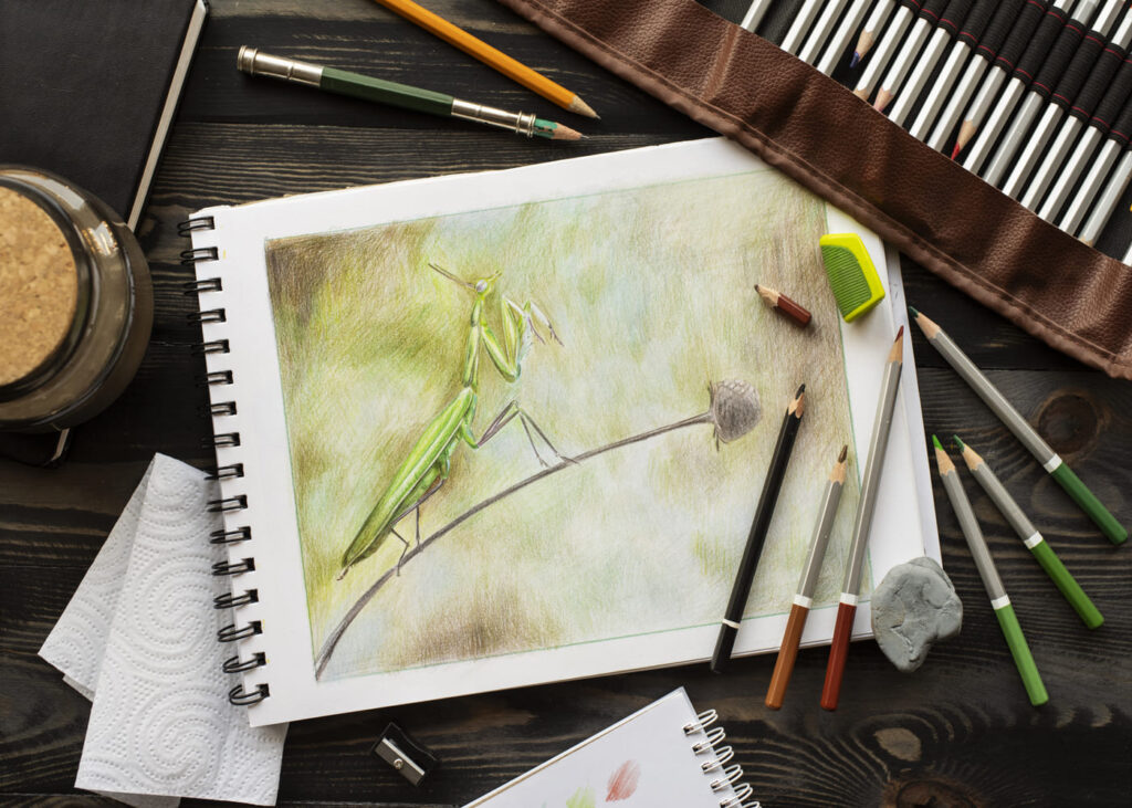 vue-du-dessus-d-un-dessin-sur-un-carnet-a-croquis-avec-des-crayons